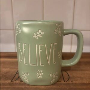 Rae Dunn “BELIEVE” Mug with flower details.